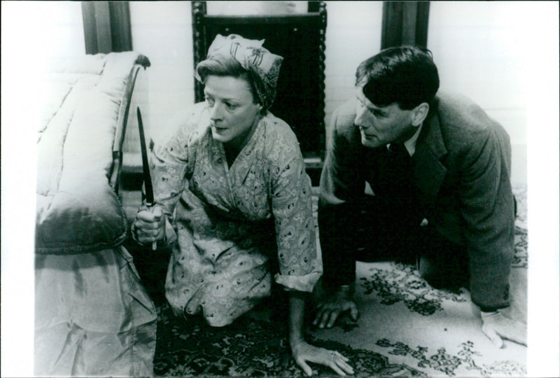 Michael Palin and Maggie Smith struggle with a stolen pig in a scene from the film "Magere Zeiten". - Vintage Photograph