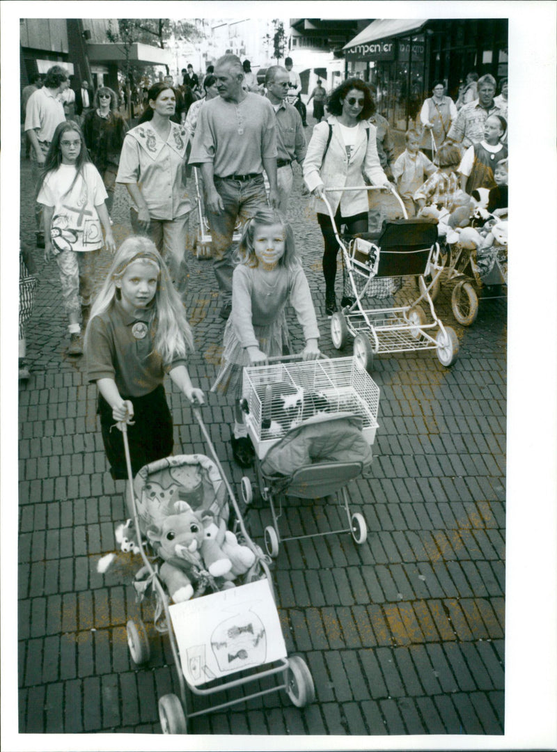 Participants in traditional Dutch dress take part in a procession with animals in Roermond, Netherlands. - Vintage Photograph