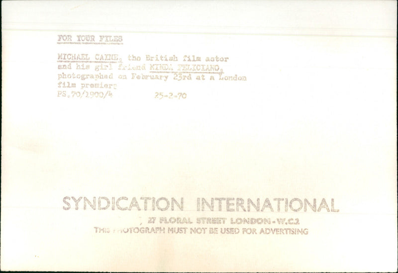 Michael Caine and his girlfriend Minda Feliciano attend a film premiere in London. - Vintage Photograph