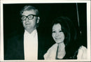 Michael Caine and his girlfriend Minda Feliciano attend a film premiere in London. - Vintage Photograph