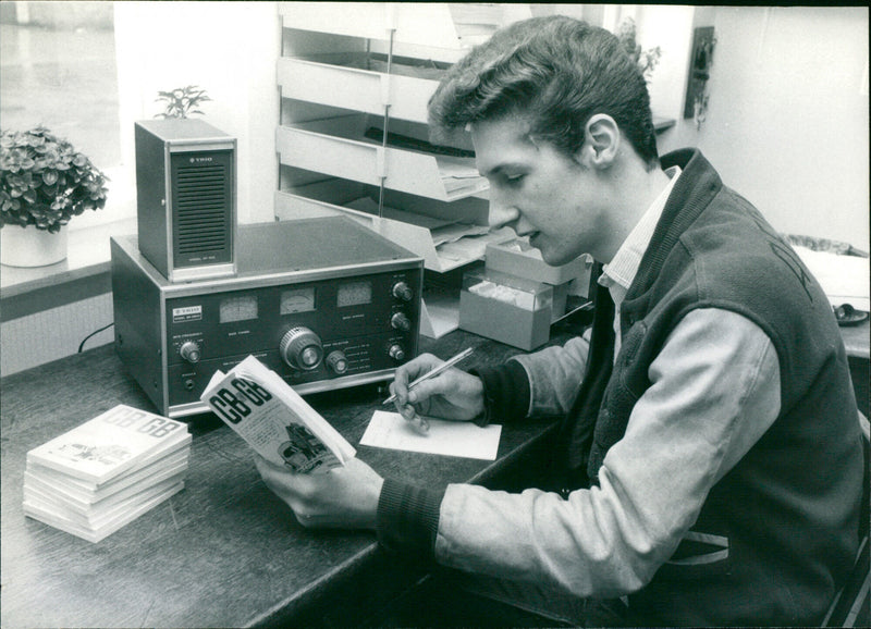 Young Man Reading a CB Book - Vintage Photograph
