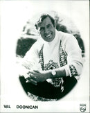 Music artist Val Doonican wearing a mask. - Vintage Photograph