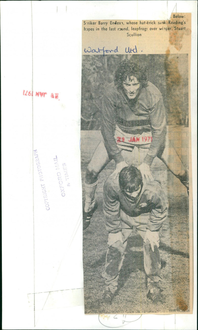 Watford United striker Barry Endean leaps over winger Stuart Scullion. - Vintage Photograph