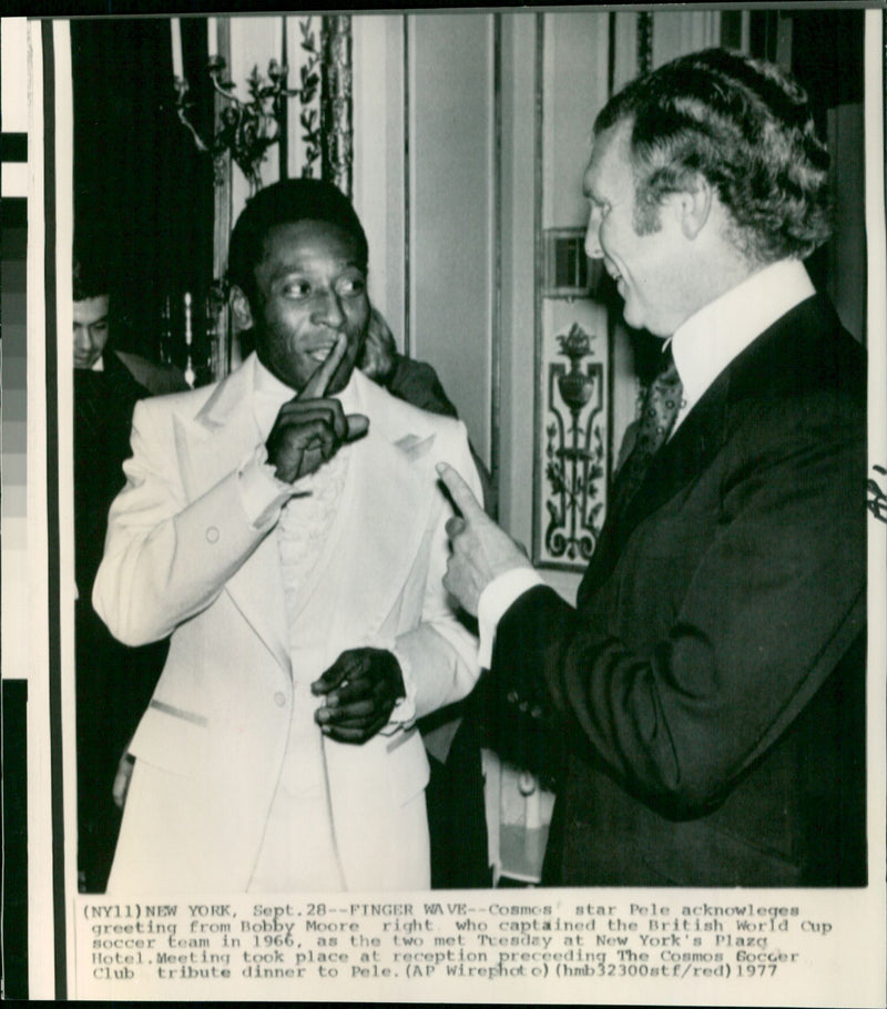 Cosmos star Pele acknowledges a greeting from Bobby Moore, the 1966 British World Cup soccer team captain, at a reception in New York City. - Vintage Photograph