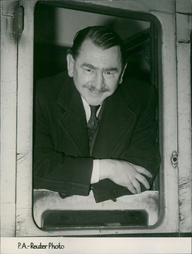 Mr. G.V. Wynne-Jones arrives in London to consult with B.B.C. representatives and lawyers after being banned from admission to a Welsh-Irish Rugby match. - Vintage Photograph