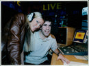 Model and singer Caprice co-presenting a live radio show. - Vintage Photograph
