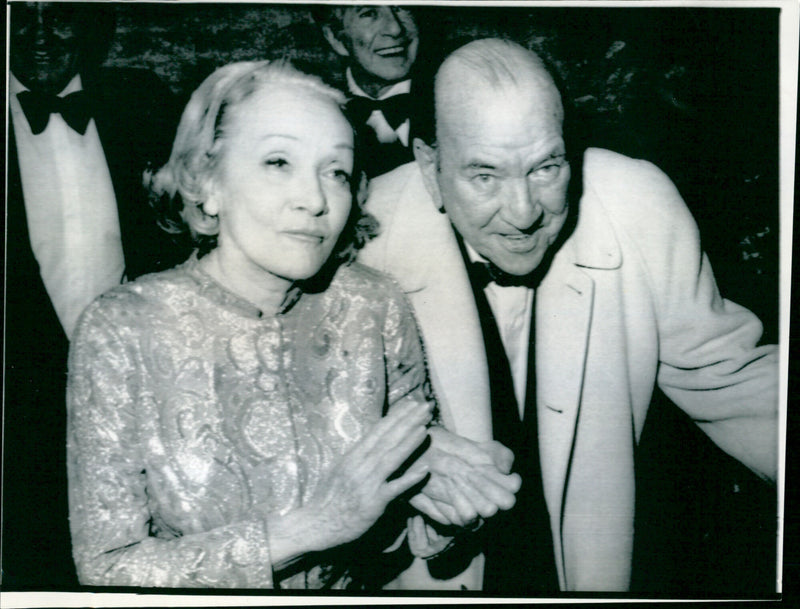 British theatrical personality Noël Coward escorts actress Marlene Dietrich at a special performance of the musical "Oh Coward" in New York City. - Vintage Photograph