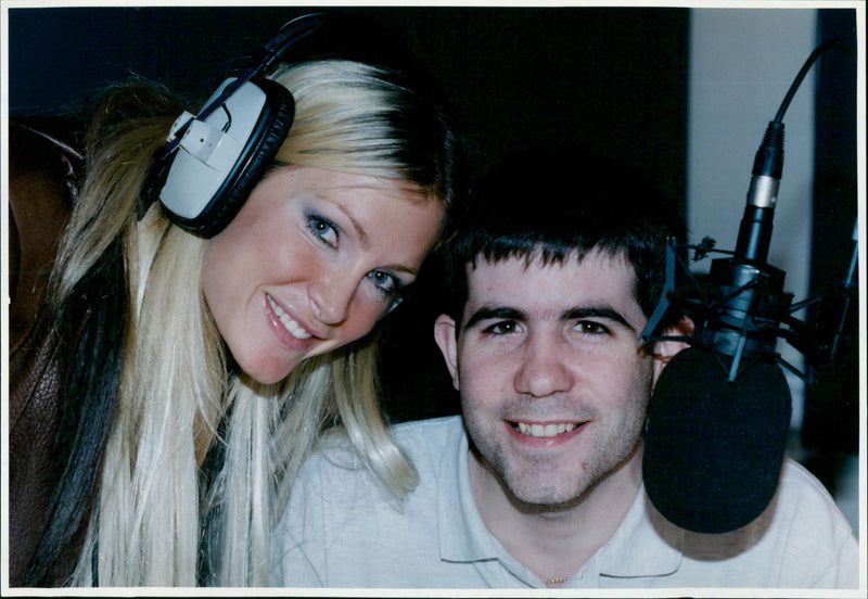 Model and singer Caprice co-presenting a radio show. - Vintage Photograph