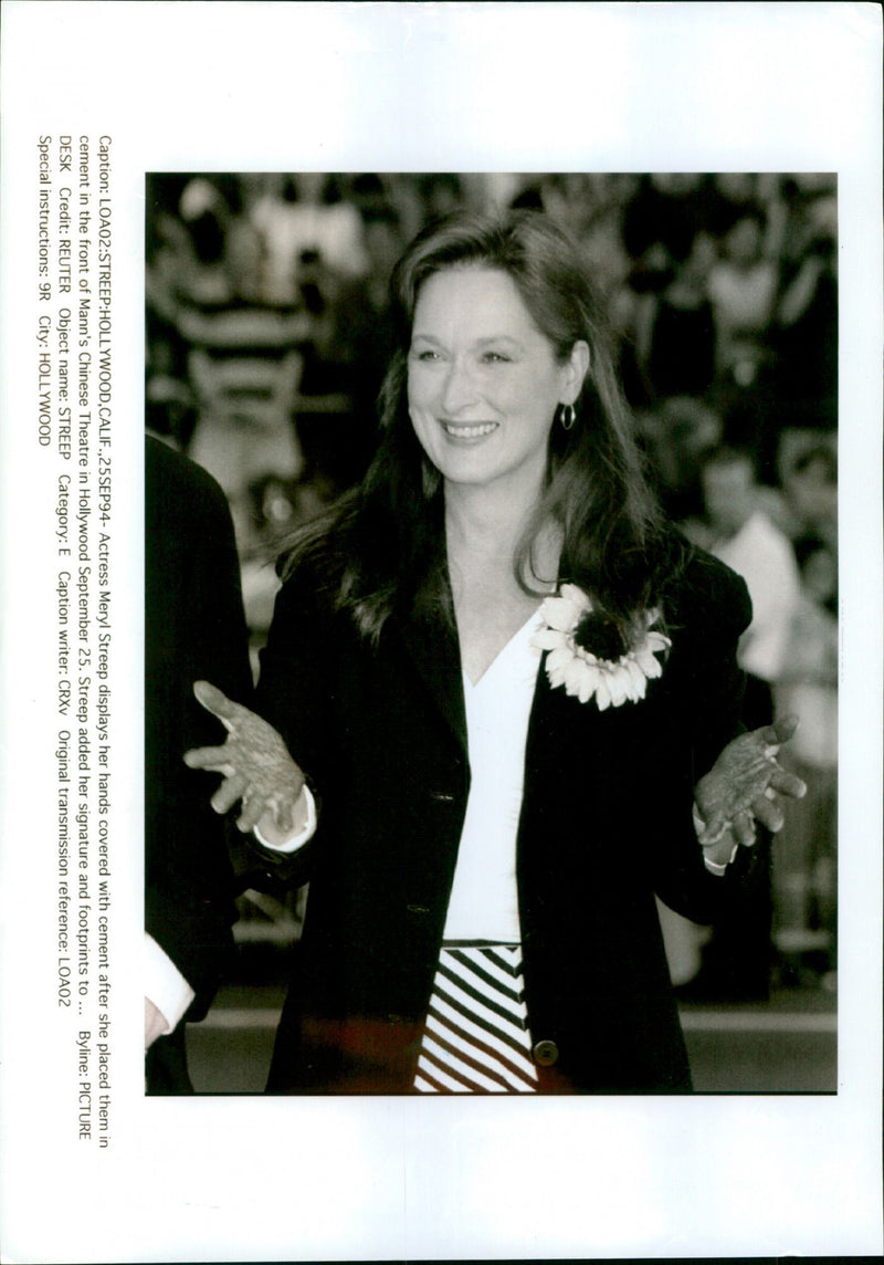 Actress Meryl Streep displays her hands covered in cement after placing them in the front of Mann's Chinese Theatre in Hollywood, California. - Vintage Photograph