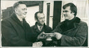Des Anderson (right) receives a silver rose bowl from mr Eric Smith - Vintage Photograph