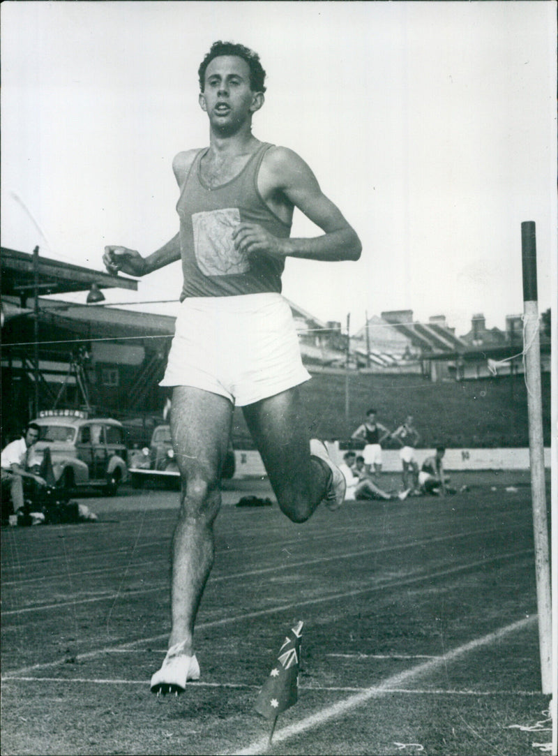 Australian miler John Landy announces he will compete in the 1956 Olympic Games in Melbourne. - Vintage Photograph