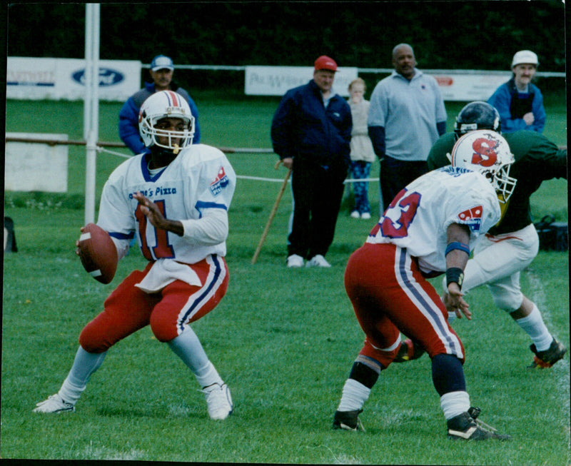 American football players Wayne Mayers, Troy Lee Smith, and Henry Johnson at the 2000 Domins T SP game. - Vintage Photograph