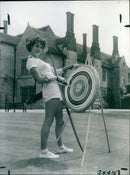 Model Shelagh Driver takes aim during a break from the fashion shows. - Vintage Photograph