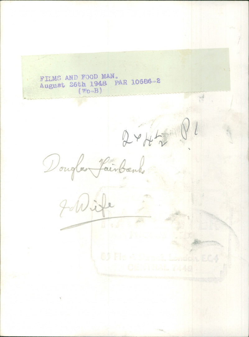 Douglas Fairbanks J. and his wife enjoying a meal and a film. - Vintage Photograph