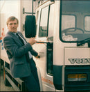 A Volvo car is parked on a street in Toa Esgll Projxo, FLS. - Vintage Photograph