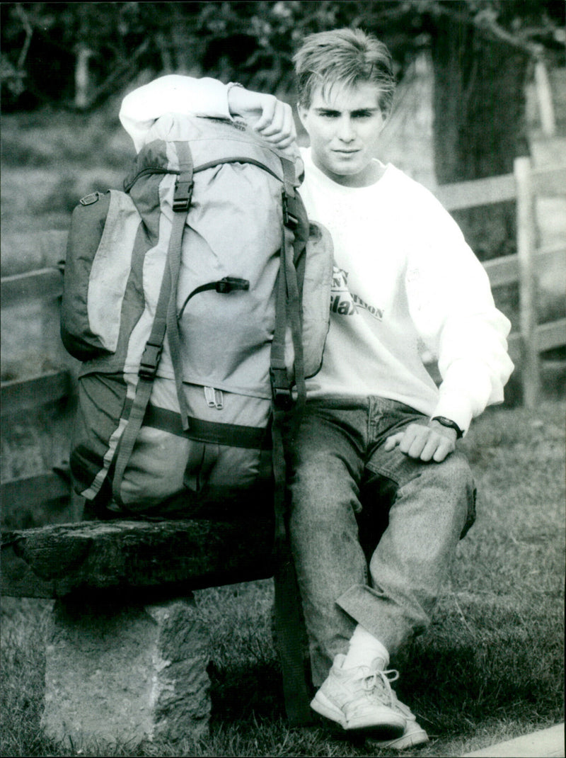 Phillip Collins proudly holds the flag from his expedition to the Himalayas. - Vintage Photograph