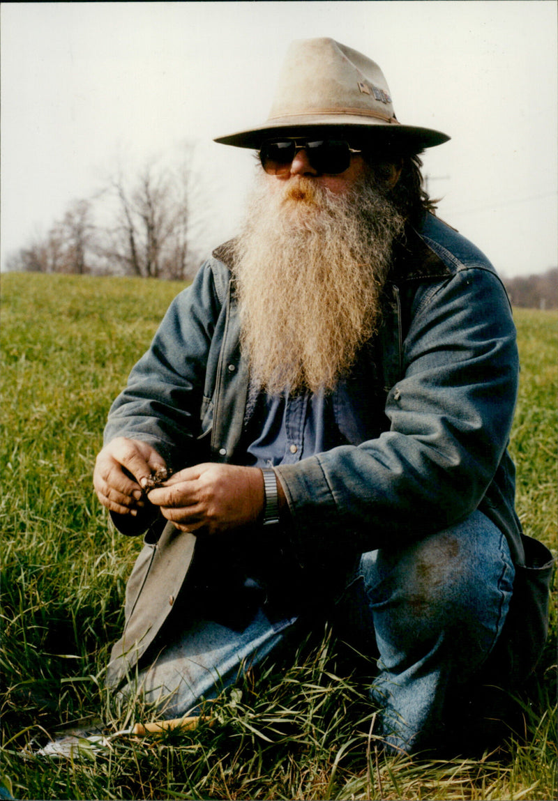 Duke Devlin, a hippy who never left the Woodstock Festival grounds, is pictured on the 25th anniversary of the legendary event. - Vintage Photograph