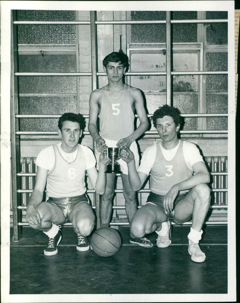 Three youth basketball players celebrate their tournament win. - Vintage Photograph