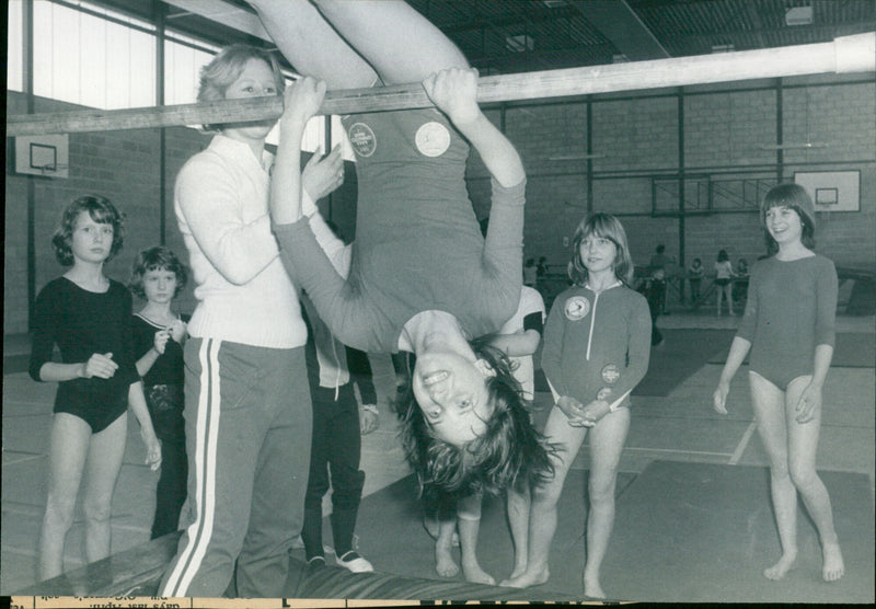 13-year-old Joanna Brown practices her gymnastics skills during an Easter School of Sport. - Vintage Photograph