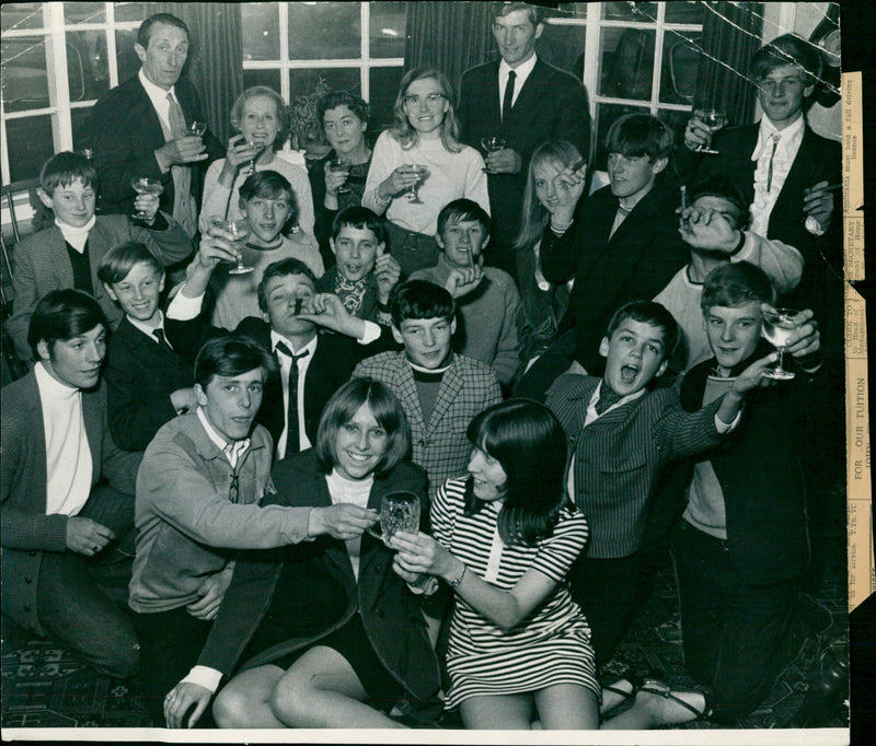 Stable lads and other well-wishers celebrate the Derby win of Blakeney at the Swan Hotel in Great Shefford, near Newbury, last night. - Vintage Photograph