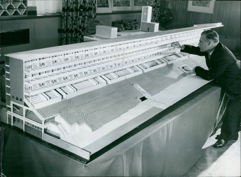 Mr. E.V. Collins examines a model of the new Tattersalls Stand at Ascot Racecourse. - Vintage Photograph