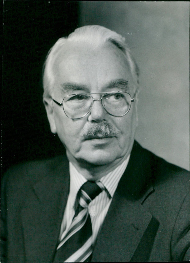 Jack Barnfield, the retiring manager of the Oxford branch of Lloyds Bank, is seen in the doorway of the bank. - Vintage Photograph