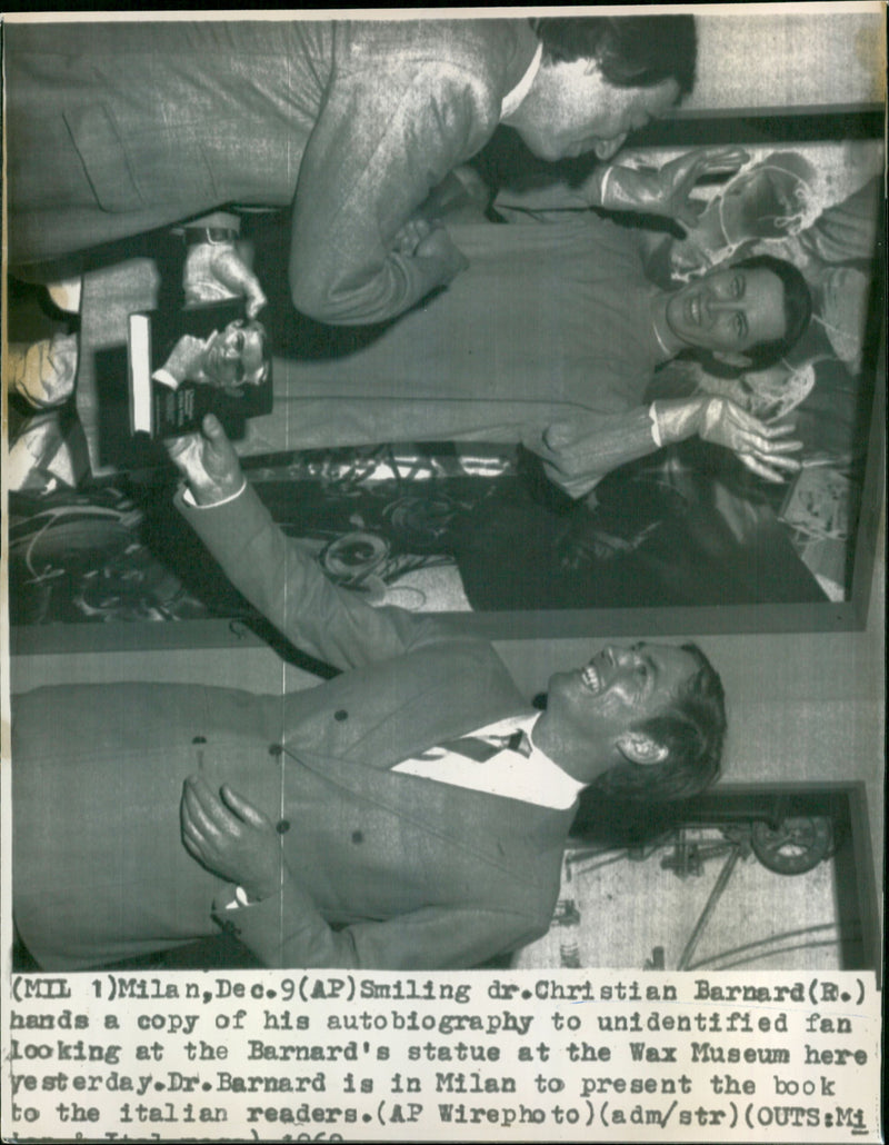 Christian Barnard hands a copy of his autobiography to unidentified fan looking at Barnards status - Vintage Photograph