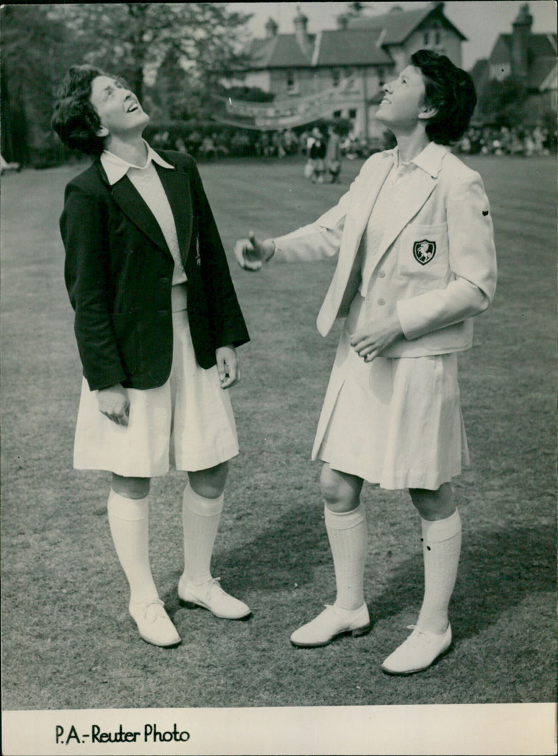 Australian cricket captain Mollie Dive and Kent skipper Celia Robins toss the coin at the opening of the women's cricket tour in Sevenoaks, Kent. - Vintage Photograph