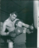 Neil swift brother of Wally Swift  receiving tuition on the punching bag - Vintage Photograph