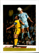 Davis Bosst of PEUGEOT Coventry competes in a football match against Cotternam Page. - Vintage Photograph