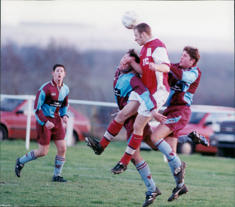 Rodney Dorrian of Didcot Town leaps above Milton's Jamie Evried and Matthew Bianchini of Didcot Town. - Vintage Photograph