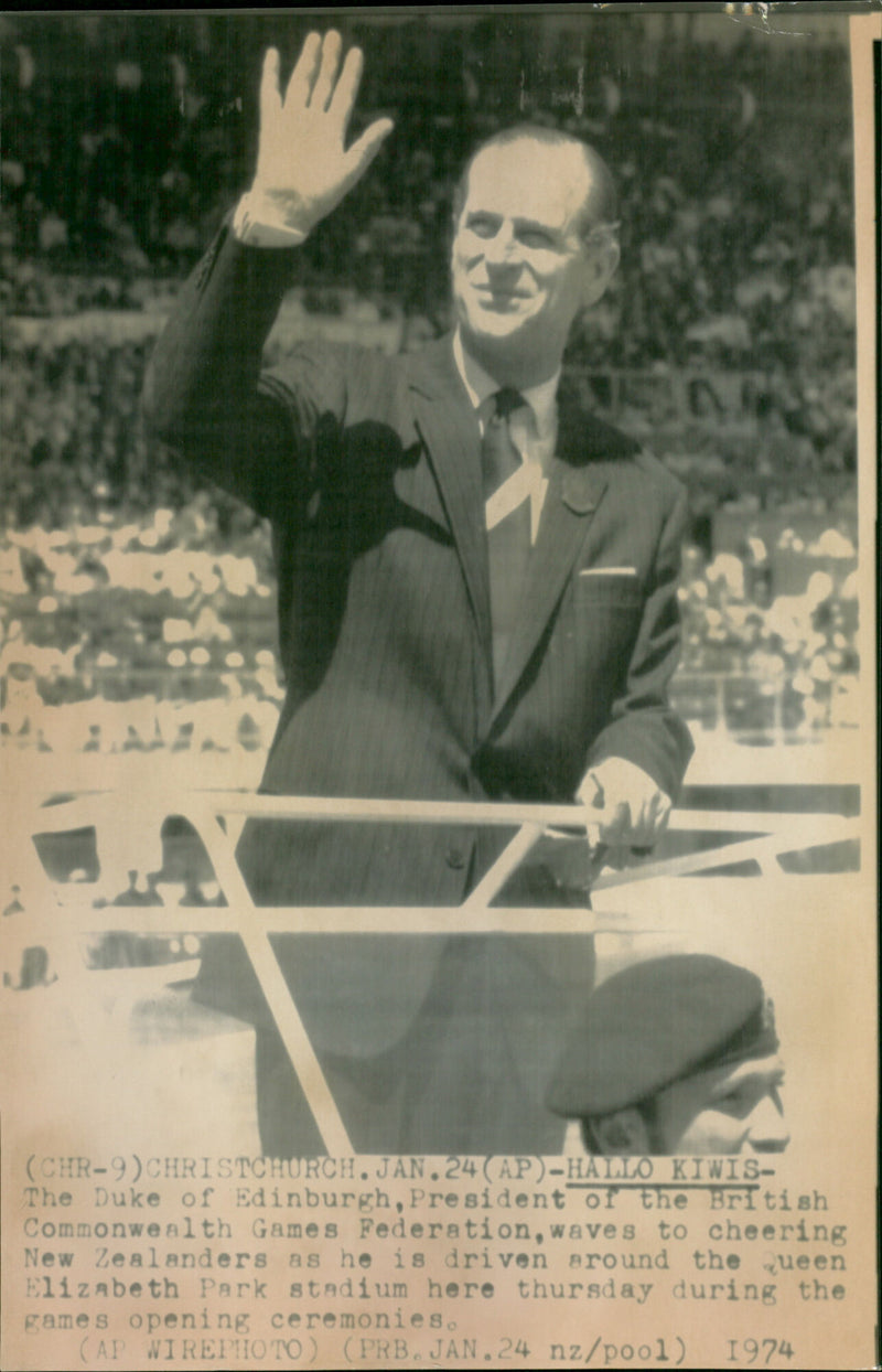 Prince Philip, the Duke of Edinburgh, greets cheering New Zealanders at the opening ceremonies of the British Commonwealth Games in Christchurch. - Vintage Photograph