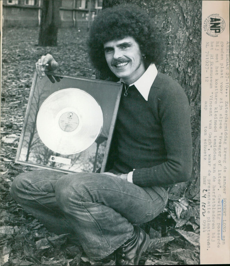 Singer Robert Long receives a gold record for his album "Vroeger of Later" in Amsterdam. - Vintage Photograph