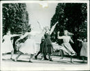 A group of people enjoying the music of a band at a local leisure center. - Vintage Photograph