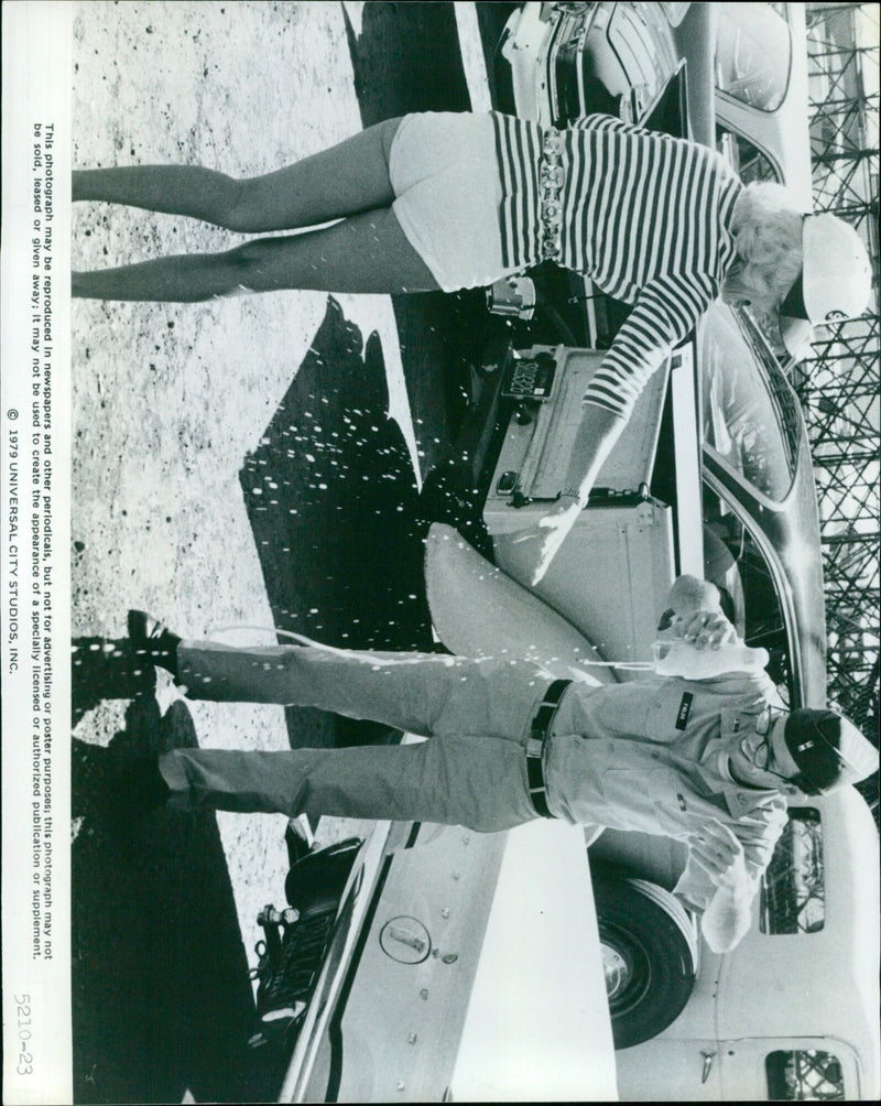 Cast and crew of the 1979 film "More American Graffiti" pose on the film's set. - Vintage Photograph