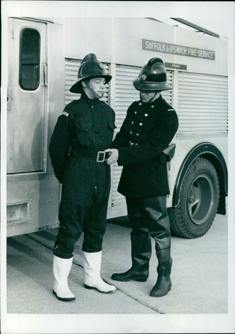 A Suffolk Fire Service cadet models the new one-piece waterproof suit being tested in the county. - Vintage Photograph