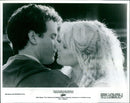 Tom Hanks and Daryl Hannah embrace in a romantic scene from the 1984 movie "Splash". - Vintage Photograph