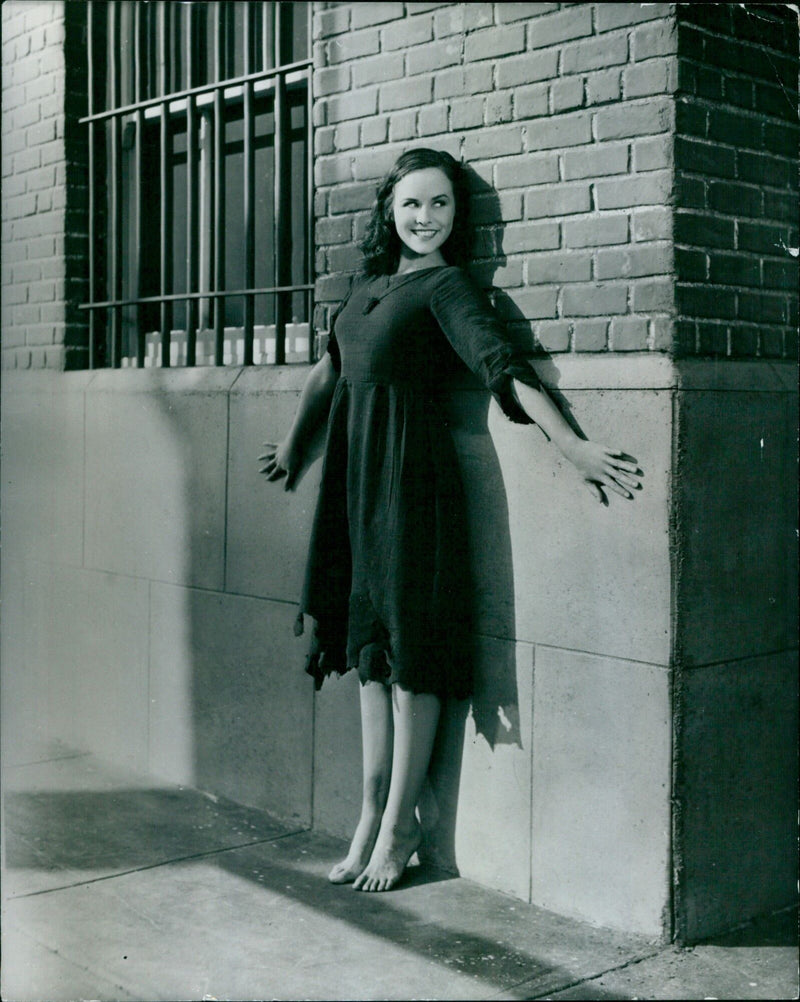 Actress Paulette Goddard poses in a scene from the 1936 film "Modern Times". - Vintage Photograph