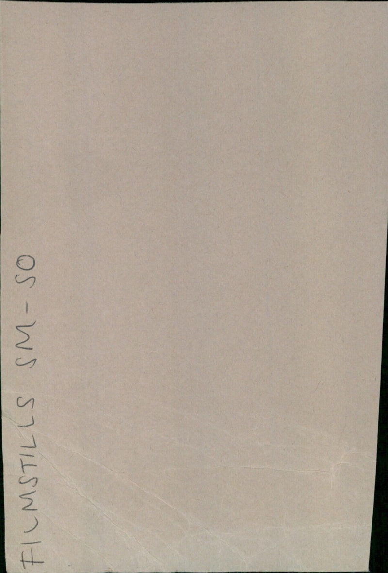 A film still from the movie SM-SO showing a woman in a lab coat. - Vintage Photograph