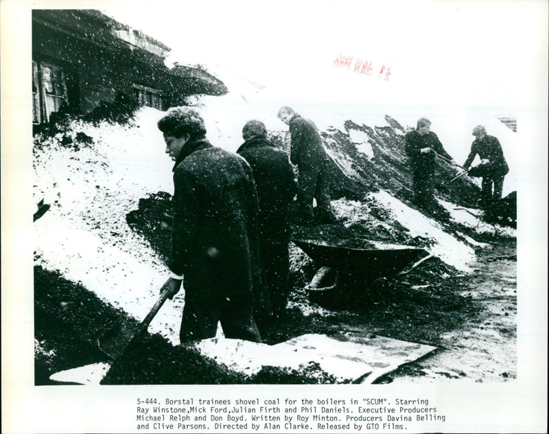 Borstal trainees shovel coal for the boilers in the 1980 film “SCUM”. - Vintage Photograph