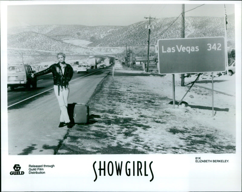 Actress Elizabeth Berkeley poses in a showgirl costume on the set of the film "Chocolate Get Showgirls" in Las Vegas. - Vintage Photograph