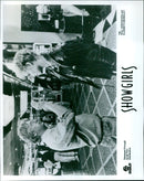 Paul Verhoeven and Elizabeth Berkeley pose with the cast of the film Showgirls. - Vintage Photograph