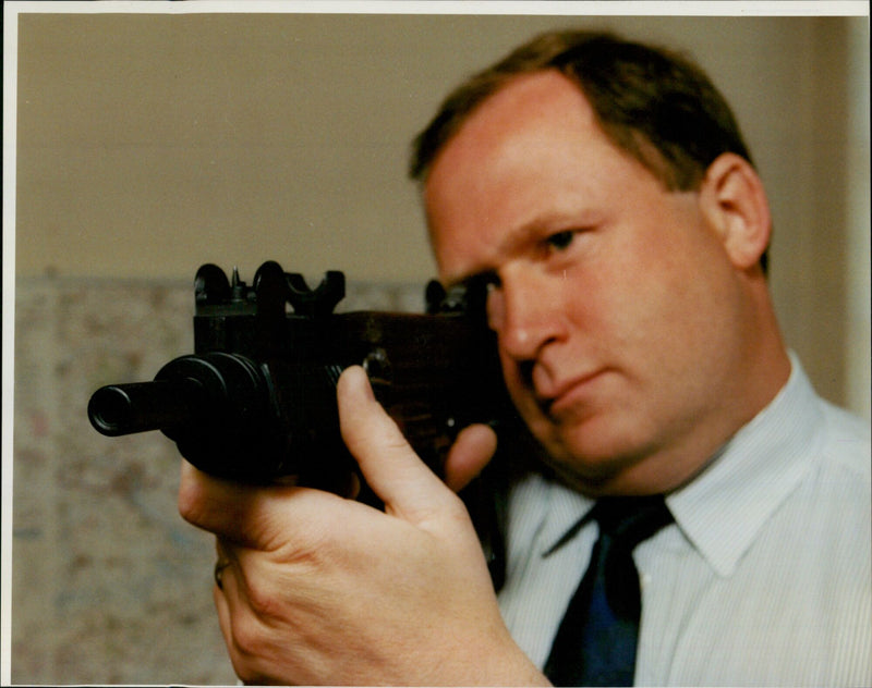 Chief Supt Ralph Perry of Oxford police holds a replica Uzi machine gun. - Vintage Photograph