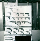 A display of various firearms models and dummy shells. - Vintage Photograph