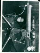 Sir Leslie Rowan, chairman of Vickers Ltd, inspects a 303 inch medium machine gun after 55 years of service with the Army. - Vintage Photograph