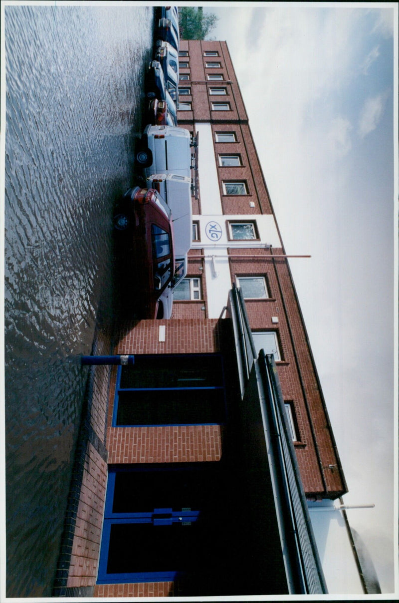 A tanker truck is removing floodwaters at Excel Timbalex Ltd in Didcot, England. - Vintage Photograph