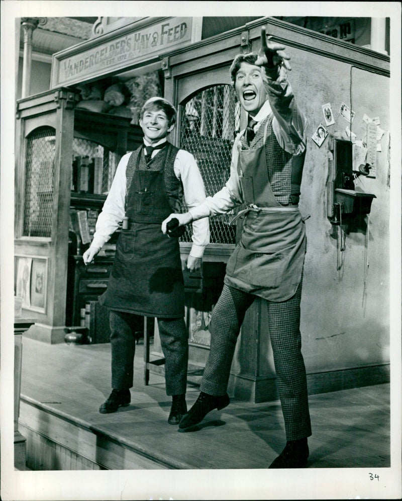 Harnaby Tucker (Danny Lockin) and Cornelius Hackl (Michael Crawford) sing "Put On Your Sunday Clothes" in preparation for their adventures in Manhattan in the musical "Hello, Dolly!". - Vintage Photograph