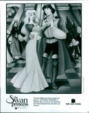 Princess Odette and Prince Derek embrace in a romantic moment from the animated film "The Swan Princess". - Vintage Photograph