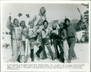 Rat Packers Harkin Banks and Dancin' Dan O'Callaghan lift Sunny in the free-style skiing comedy "Hot Dog... The Movie". - Vintage Photograph