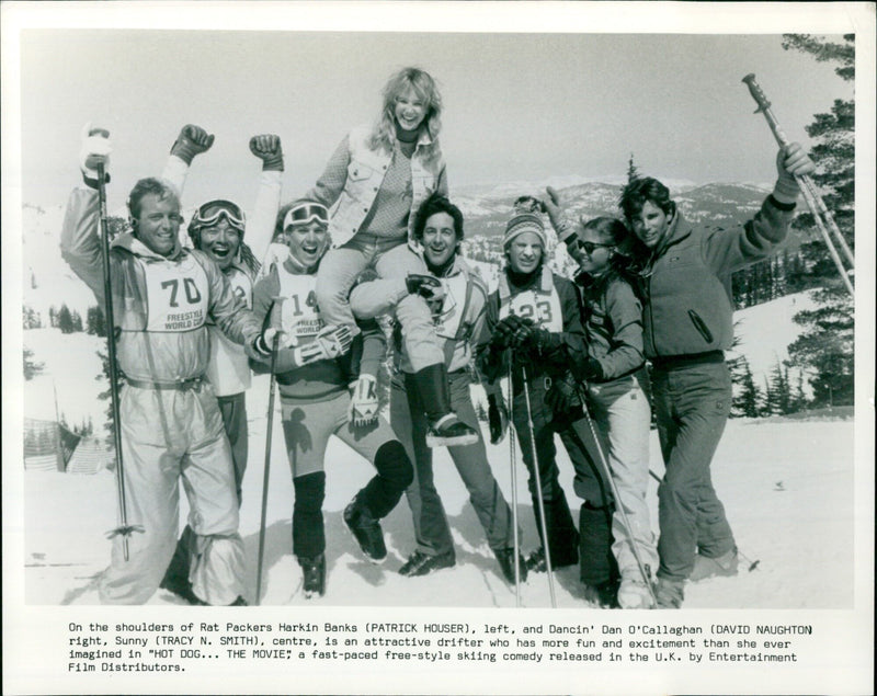 Rat Packers Harkin Banks and Dancin' Dan O'Callaghan lift Sunny in the free-style skiing comedy "Hot Dog... The Movie". - Vintage Photograph